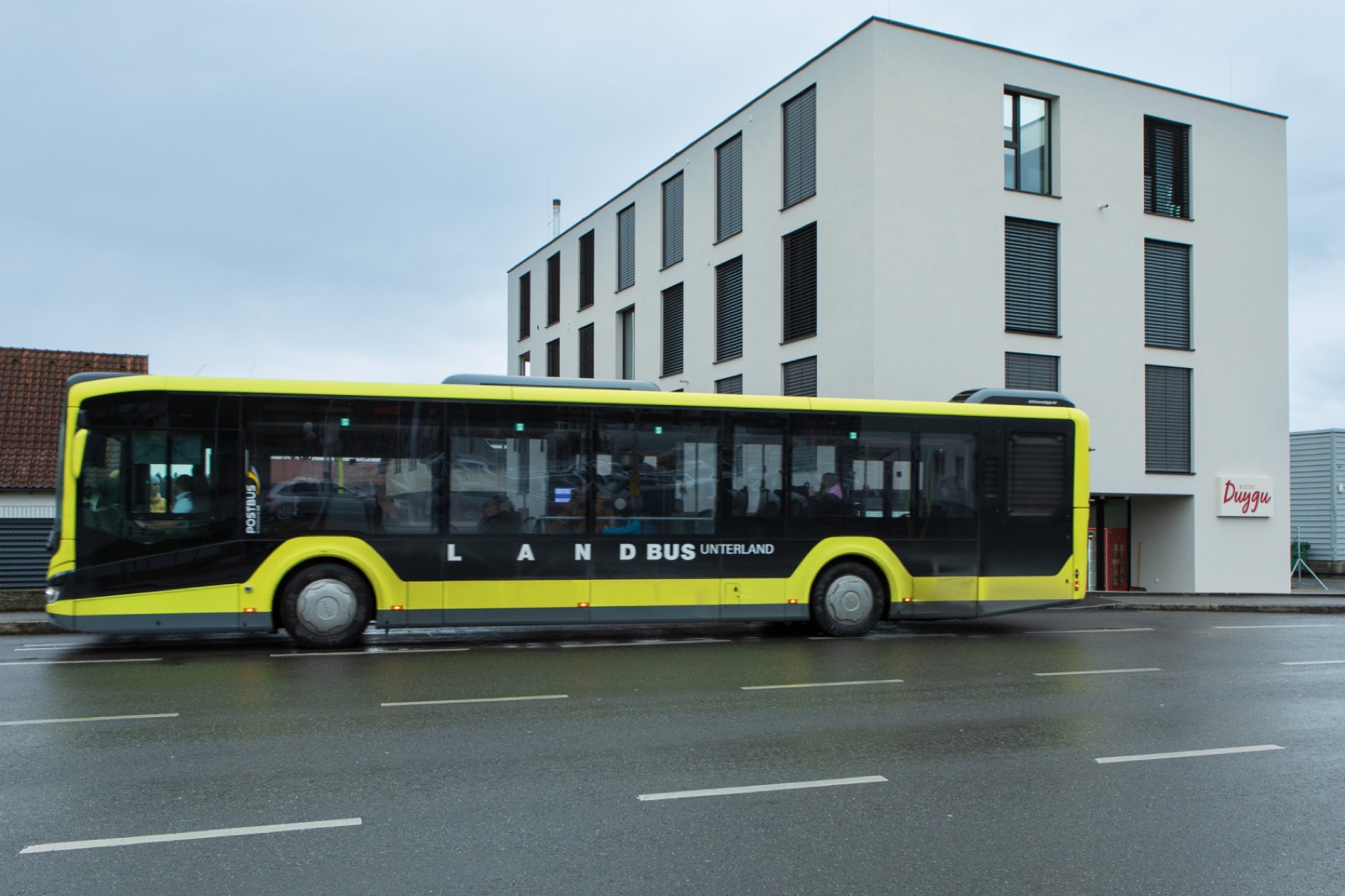 Landbus an der Haltestelle vor dem Apartmenthaus in Hard