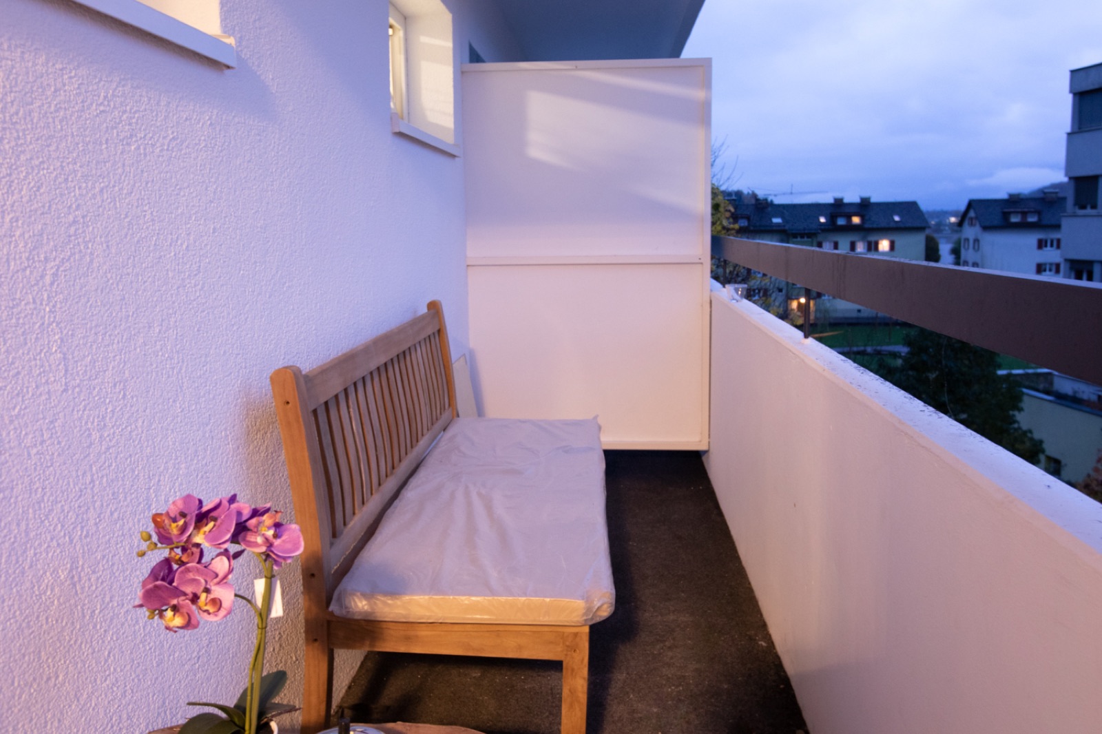 Balcony with bench in the evening at Comfort Apartment No 47 in Götzis